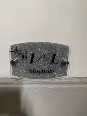 a metal plate on a wall with the word maybia at Nelson st (MAYBOLE) in Largs