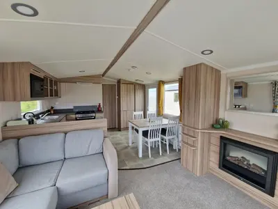 a living room with a couch and a fireplace at Machrihanish Holiday Park in Campbeltown