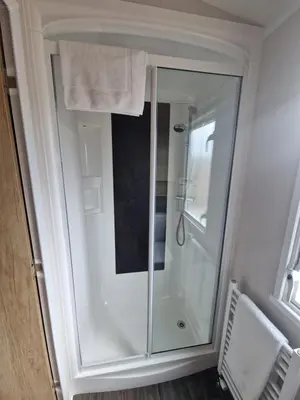 a shower with a glass door in a bathroom at Machrihanish Holiday Park in Campbeltown