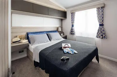 a bedroom with a bed with a hat on it at Machrihanish Holiday Park in Campbeltown