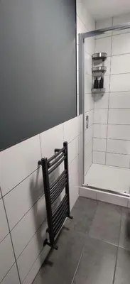a bathroom with a shower with a bench in it at Anchors Rest in Ayr