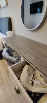 a table in a drawer with a mirror on the wall at Anchors Rest in Ayr