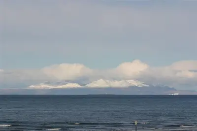 a large body of water with snow covered mountains in the background at Links Quay 42 in Prestwick