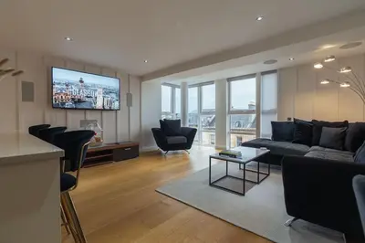 a living room with a couch and a tv at The Penthouse Suite - Luxury Like No Other in Glasgow