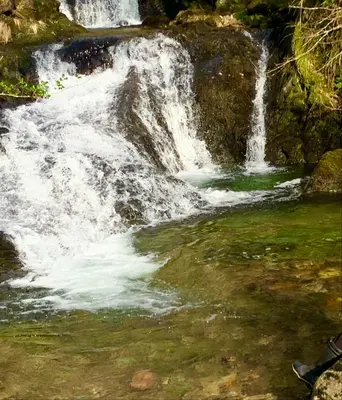 a waterfall on the side of a river at Linnhe Apartment, Kinlochlaich House in Appin