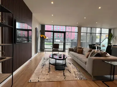 a living room with a couch and a table at Stunning Apartment at Glasgow Hydro & SECC - Glasg in Glasgow