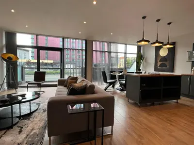 a living room with a couch and a table at Stunning Apartment at Glasgow Hydro & SECC - Glasg in Glasgow