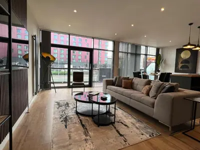 a living room with a couch and a table at Stunning Apartment at Glasgow Hydro & SECC - Glasg in Glasgow