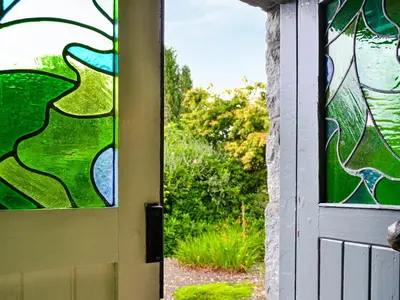 a door with a stained glass window on it at Oakwood Cottage - Glencoe in Glencoe