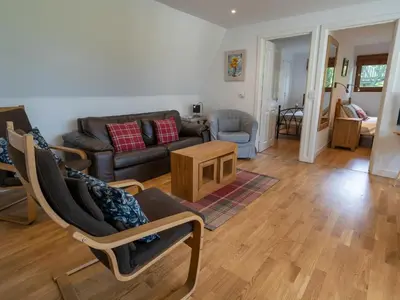 a living room with a couch and a table at Ledi - Cottage in Linlithgow