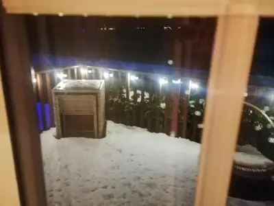 a window view of a building with snow on it at Salmon-Leap Lodge in Dollar
