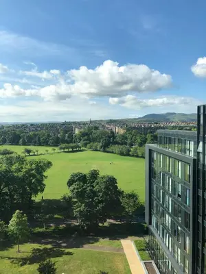 an apartment building with a view of a green field at Simpsons Loan - 428 in Edinburgh