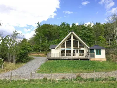 a large house with a porch on a hill at Tunturi - Cottage in Linlithgow