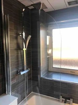 a bathroom with a shower with a glass door at Cosy Home with Free Parking Near Edinburgh St Andrews M90 & Amazon in Dunfermline