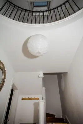 a spiral staircase with a ceiling with a window at Tower Square House in Alloa