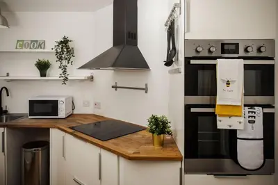 a kitchen with a stove top oven and a counter top at Tower Square House in Alloa