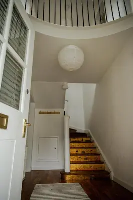 a hallway with stairs and a ceiling with a door at Tower Square House in Alloa