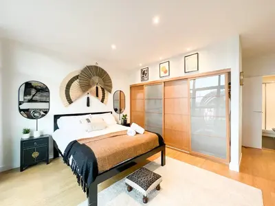 a bedroom with a bed and a mirror at Lovely 2 Bed Duplex Apartment with Hydro Views in Glasgow