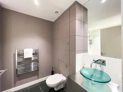 a bathroom with a sink and a toilet at Lovely two bed apartment in Finnieston in Glasgow