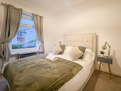 a bedroom with a large bed and a window at Attractive 3 Bedroom Apartment in Polmadie