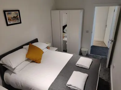 a bedroom with a large white bed with two pillows at No 7 Westbay Apartment in Oban