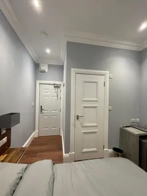 a bedroom with a bed and a white door at Laurieston Inn in Falkirk