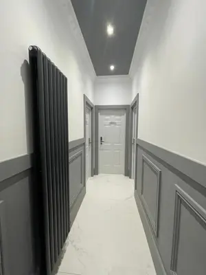 a hallway with white walls and a white door at Laurieston Inn in Falkirk