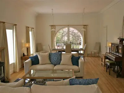 a living room with a couch and a table at The Coach House at Stewart Hall in Rothesay