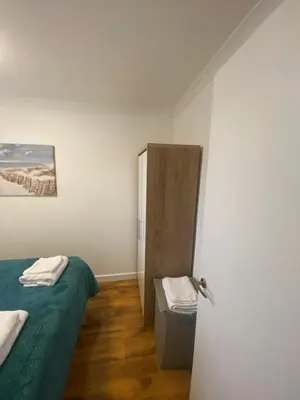 a room with two beds and a door in it at cosy 1 bed flat Largs in Largs