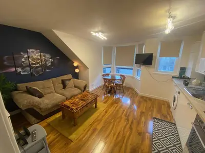 a living room with a couch and a table at cosy 1 bed flat Largs in Largs