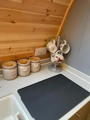 a kitchen counter with pots and pans and a sink at Glamping Pods in Milngavie