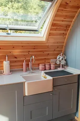 a kitchen with a sink and a window at Glamping Pods in Milngavie