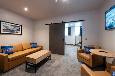 a waiting room with a couch and a table at Sandman Signature Glasgow Hotel in Glasgow