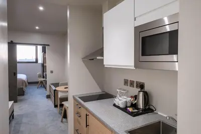 a kitchen with a sink and a counter top at Sandman Signature Glasgow Hotel in Glasgow