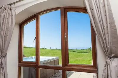 a room with a window with a view of a field at Beech Cottage at Williamscraig Holiday Cottages in Linlithgow