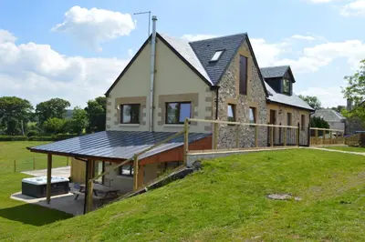 a house with a solar panel on the side of it at The Farmhouse at Williamscraig Holiday Cottages in Linlithgow