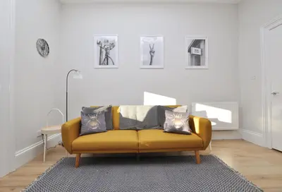a living room with a yellow couch with pillows at The Warren Apartment in Greenock