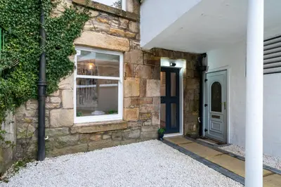 a stone house with a door and a window at The Wilton Suite - Your Private 5* Escape! in Glasgow