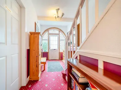 a hallway with a stairway with a door and a room at Charles House in Largs