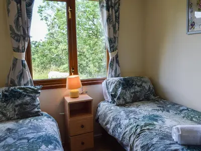 two beds in a room with a window at Teasel Lodge - Uk39647 in Lunga