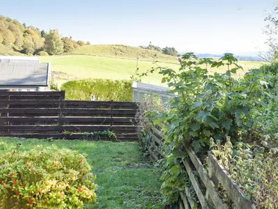 a set of stairs in a garden with a fence at Daisybank Cottage in Crieff