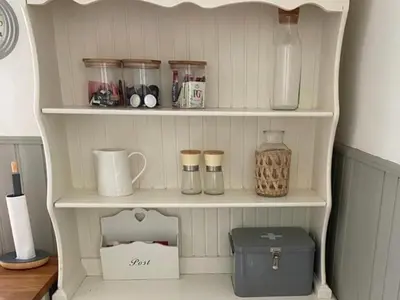 a shelf in a kitchen with jars and a box at Traditional Cottage in West Kilbride Village in Seamill