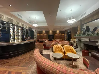 a lobby of a hotel with couches and a fireplace at Fabulous Lodges at Cameron House, Loch Lomond in Balloch