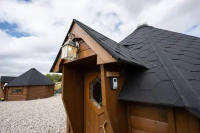 a wooden cabin with a black roof at Leven View Lodges - Callart in Fort William