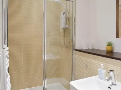 a shower with a glass door in a bathroom at Modern 2BD2Bath Apart CityCentre in Glasgow