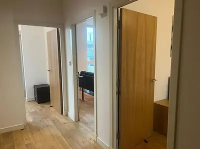 a hallway with a door and a room with a piano at Modern 2BD2Bath Apart CityCentre in Glasgow