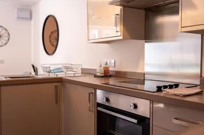 a kitchen with a sink and a stove top oven at Lagavulin Apartment in Oban
