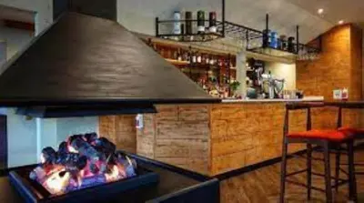 a kitchen with a bar with a large stove at Bell Rock Holiday Lodge in Killin