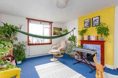 a living room with plants and a hammock in it at Bright & Spacious Double Room with Garden View- Close to Airport & City Centre in Edinburgh