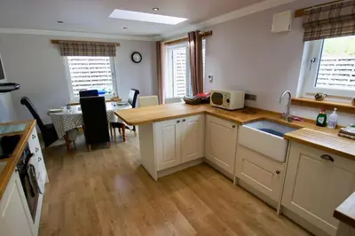 a kitchen with a sink and a counter top at The Old Schoolhouse Lochearnhead in Lochearnhead